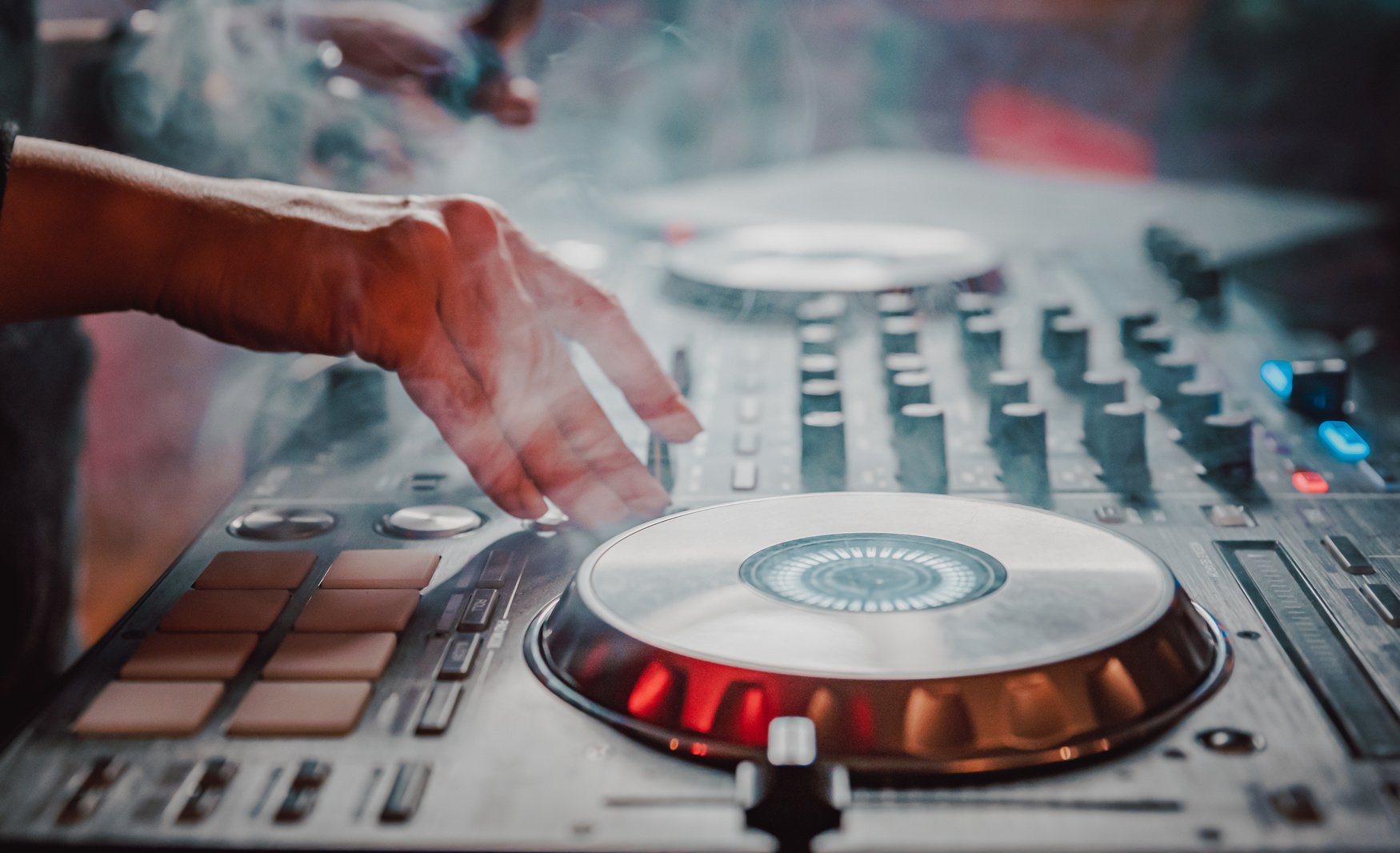 DJ Hands creating and regulating music on dj console mixer in concert nightclub stage